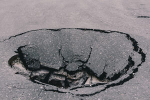 Deep,Sinkhole,On,Asphalt,With,Cracks